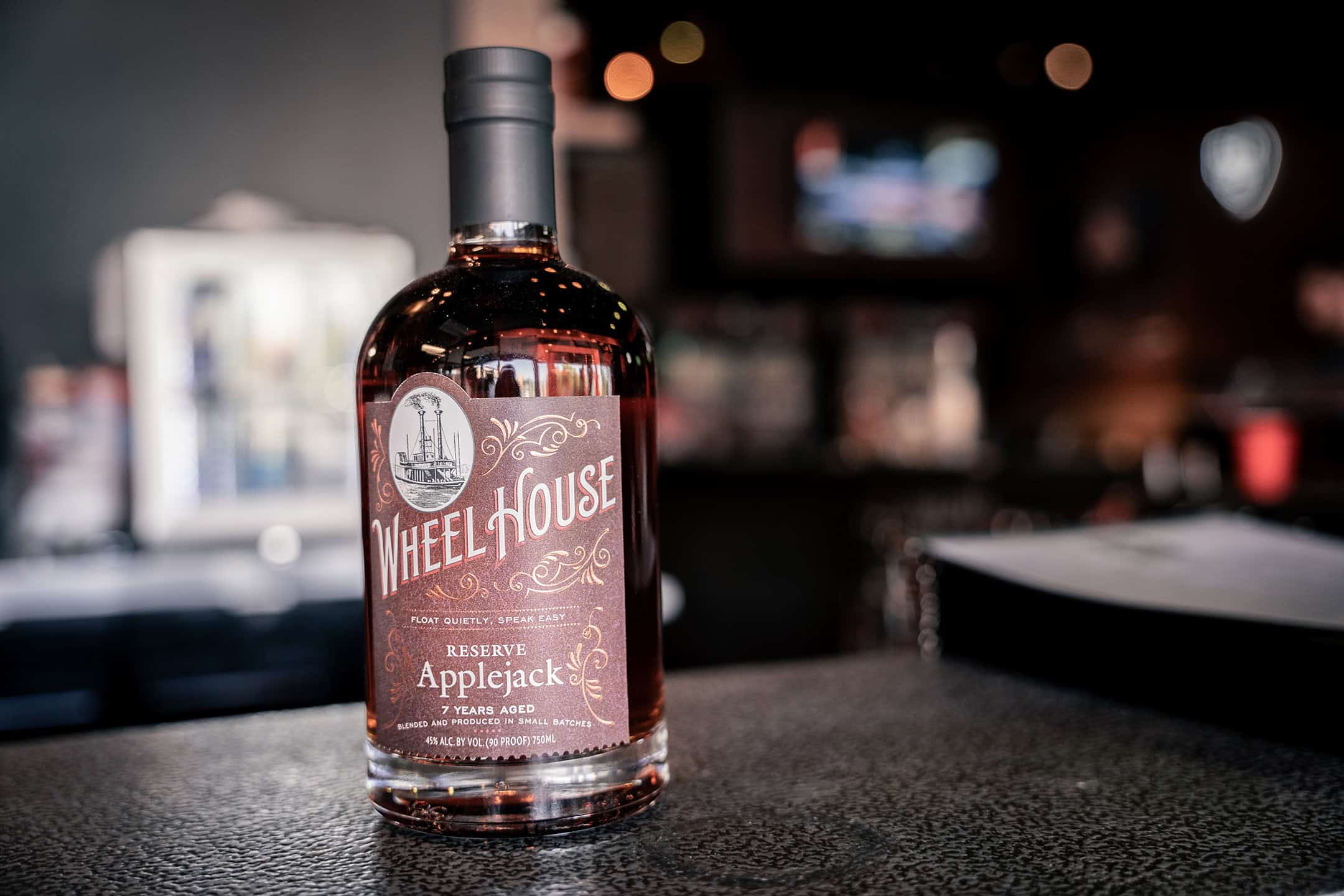 Wheelhouse Reserve Applejack bottle on the bar at Rock Hard Burgers & Brew