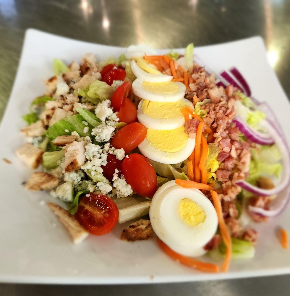 Loaded Cobb salad with bacon, egg, tomato, and cheese at Rock Hard Burgers & Brew