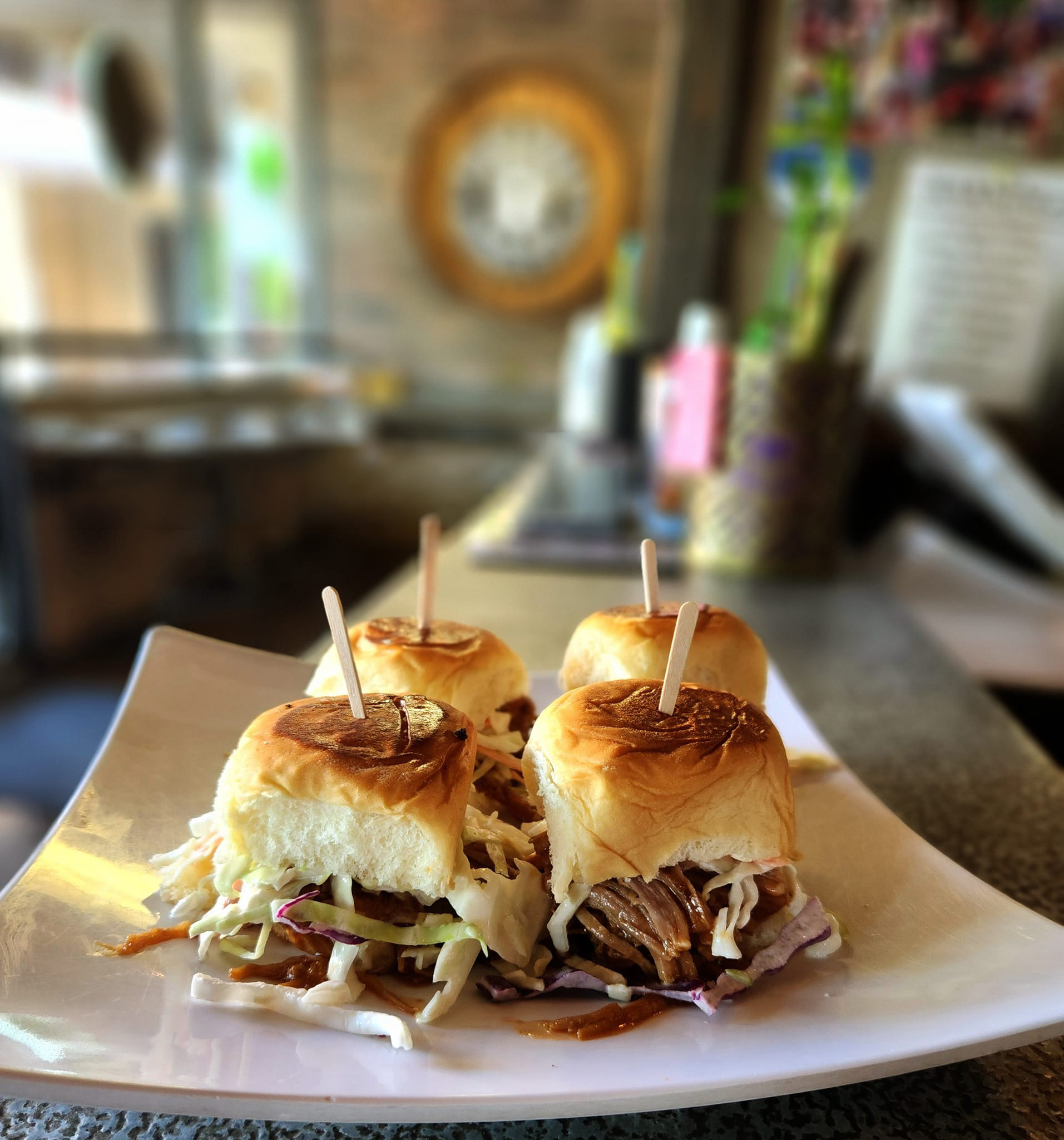 Handcrafted slider trio on a plate at Rock Hard Burgers & Brew in Citrus Heights