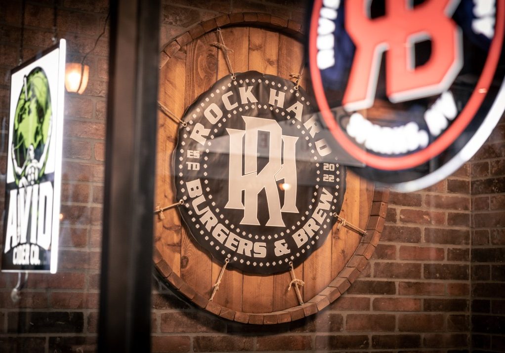 A sign on the wall of a bar with a sign that reads rbb.